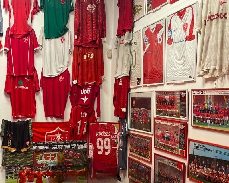 Parete di maglie storiche della Triestina e foto delle squadre al Bar Capriccio Trieste